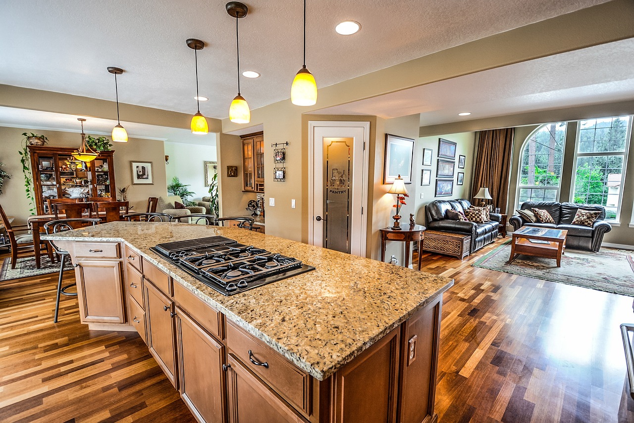 Installers setting a stone kitchen countertop in a Round Rock home